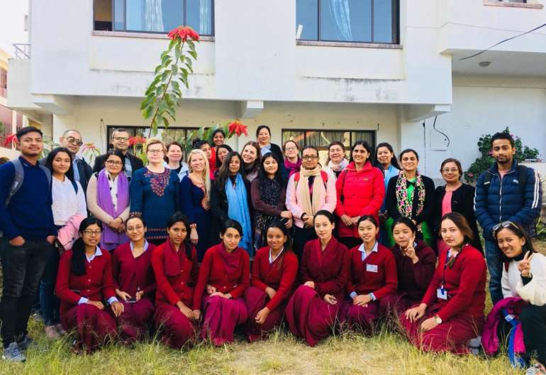 A large group of students in Nepal, Tahmandu and their foreign teachers from Finland.