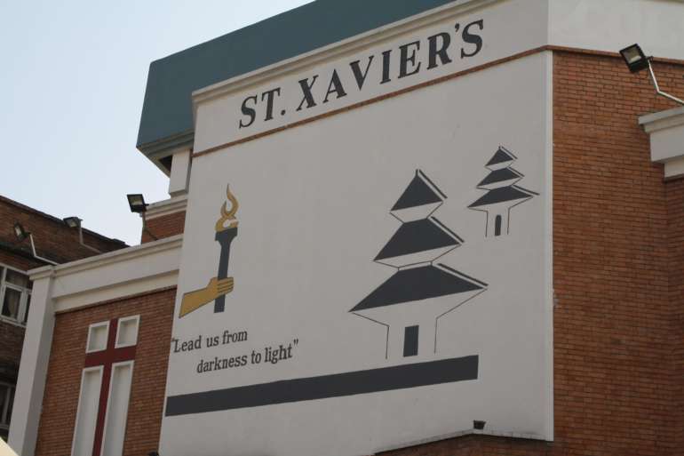 Wall of St. Xavier´s University in Nepal saying "Lead us from darkness to light"