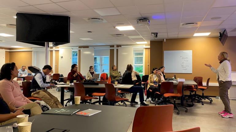 students and teachers sitting in a classroom